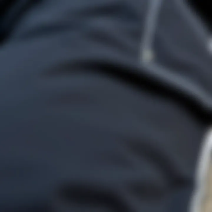 Close-up of the fabric texture of black pants with a side stripe in natural light