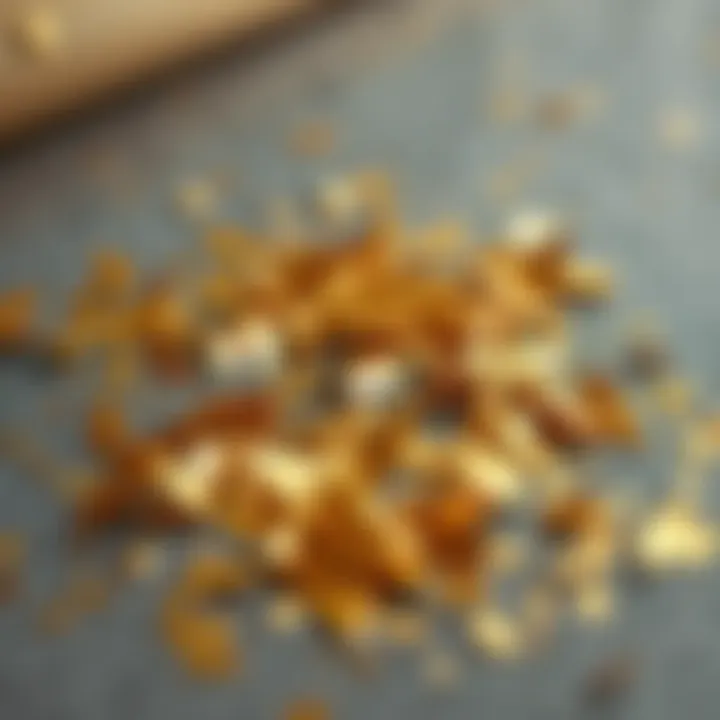 Artistic Display of Gold Foil Flakes An artistic arrangement of gold foil flakes on a textured surface