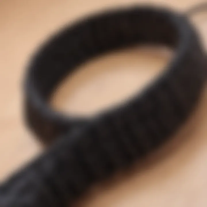 Close-up view of a black hair tie showcasing its robust material and design