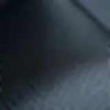 Close-up view of 5D carbon fiber vinyl texture showcasing its unique pattern.